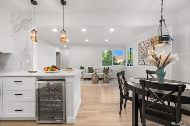 3541 Eudora St, Denver, CO 80207 - dining space with wine cooler, recessed lighting, light wood-style floors, and a dry bar