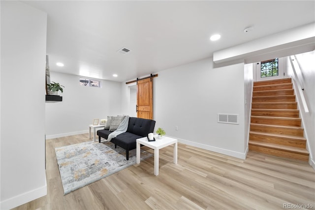 3541 Eudora St, Denver, CO 80207 - living area with a barn door, stairs, light wood finished floors, baseboards, and recessed lighting