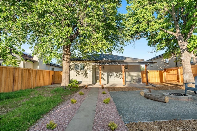 3541 Eudora St, Denver, CO 80207 - rear view of house with an outdoor fire pit, a patio, and a fenced backyard