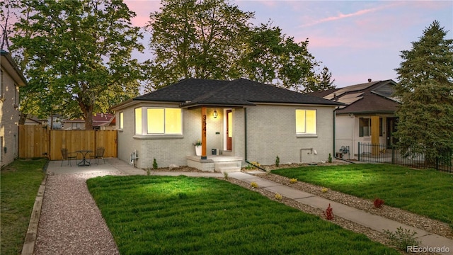 3541 Eudora St, Denver, CO 80207 - view of front of house with a patio, brick siding, and roof with shingles