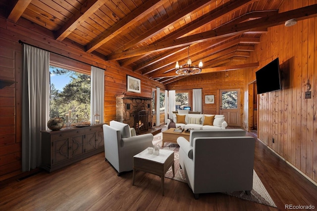 living room featuring lofted ceiling with beams, a stone fireplace, wooden ceiling, wooden walls, and dark wood-type flooring