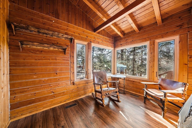 living area with lofted ceiling with beams, hardwood / wood-style floors, wood ceiling, and a wealth of natural light