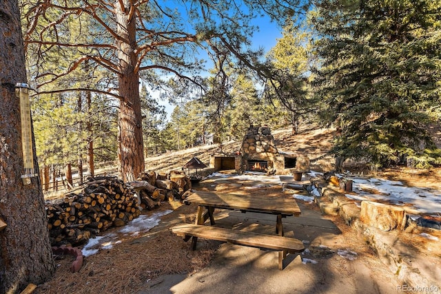 exterior space featuring an outdoor stone fireplace and a patio