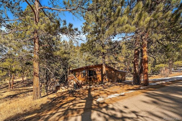 rustic home featuring a wooded view