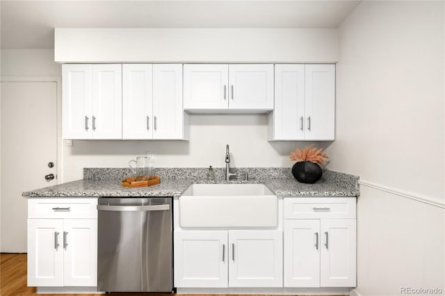 3054 S Raleigh St, Denver, CO 80236 - kitchen with dishwasher, a sink, white cabinets, light stone countertops, and wainscoting
