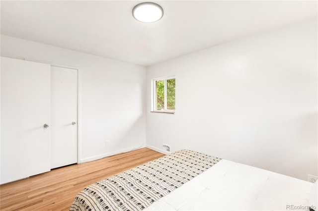 3054 S Raleigh St, Denver, CO 80236 - unfurnished bedroom with light wood finished floors and baseboards