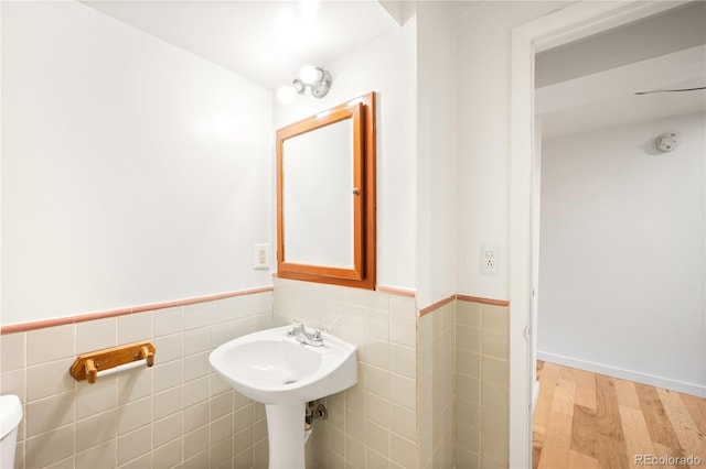 3054 S Raleigh St, Denver, CO 80236 - bathroom featuring wood finished floors, tile walls, wainscoting, and toilet