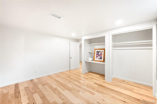 3054 S Raleigh St, Denver, CO 80236 - unfurnished bedroom with wood finished floors, two closets, recessed lighting, and baseboards