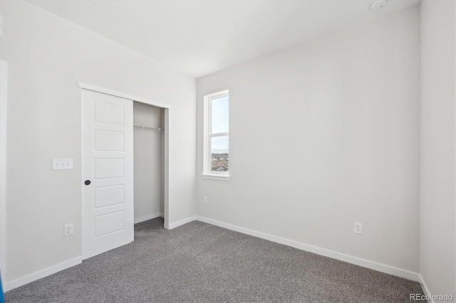 unfurnished bedroom with carpet and a closet