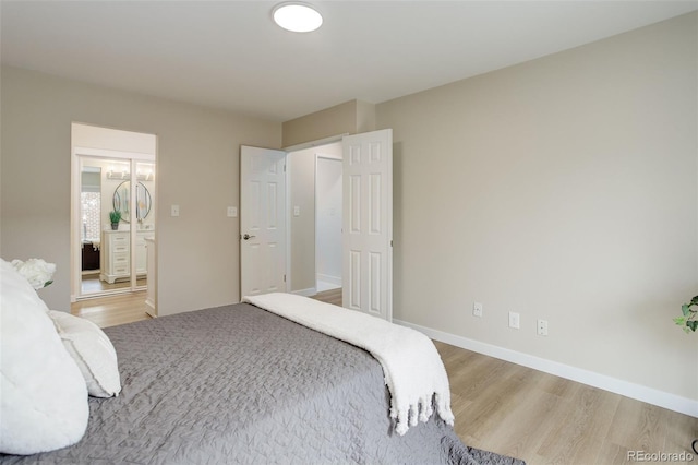 bedroom with baseboards and wood finished floors