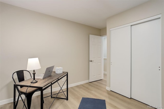 office featuring baseboards and light wood-style floors
