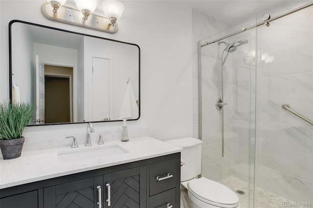 bathroom featuring toilet, vanity, and a stall shower