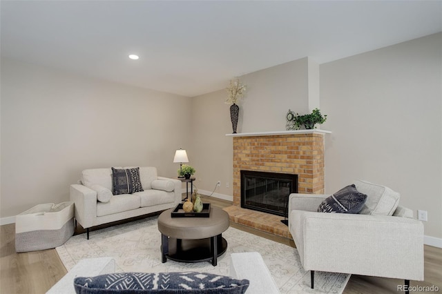 living room with baseboards, recessed lighting, wood finished floors, and a fireplace
