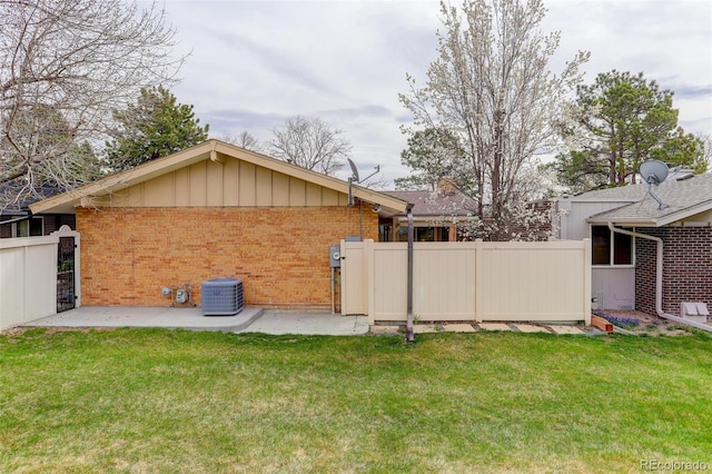 view of yard with a patio area, central AC, and fence