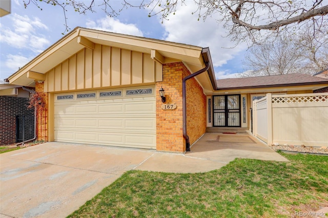 single story home featuring an attached garage, board and batten siding, fence, brick siding, and driveway