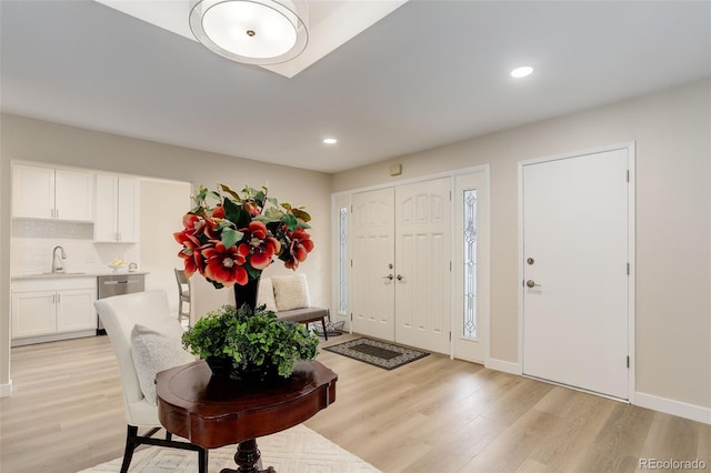 entryway with baseboards, recessed lighting, and light wood-style floors