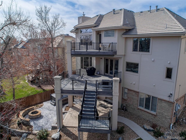 11465 W Atlantic Ave, Lakewood, CO 80227 - rear view of house with a fire pit, a patio, a balcony, a chimney, and fence
