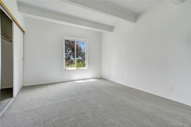 2525 S Dayton Way Unit 1510, Denver, CO 80231 - unfurnished bedroom featuring carpet flooring, a textured ceiling, beamed ceiling, and a closet