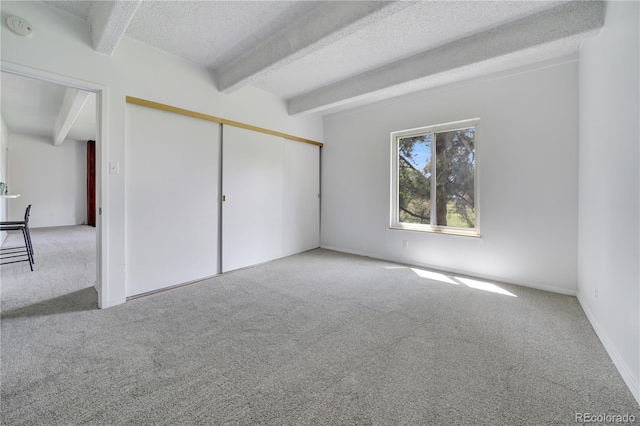 2525 S Dayton Way Unit 1510, Denver, CO 80231 - unfurnished bedroom with carpet floors, beamed ceiling, a textured ceiling, and a closet