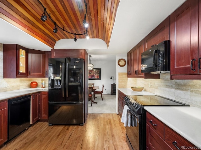 5845 W Portland Dr, Littleton, CO 80128 - kitchen with black appliances, reddish brown cabinets, wooden ceiling, and light wood-style flooring