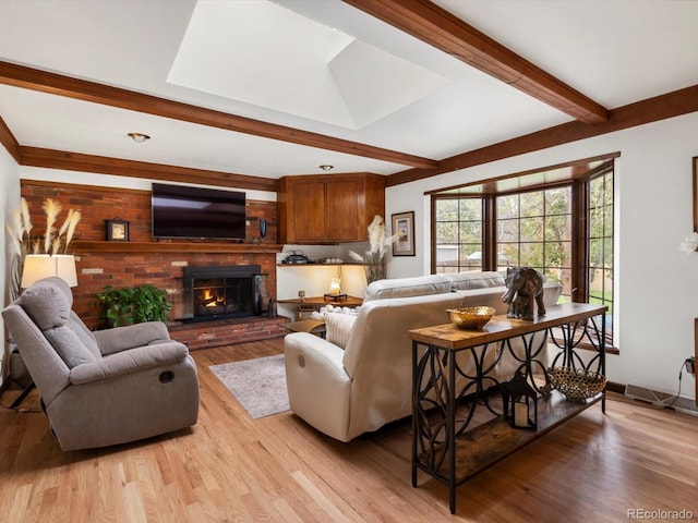 5845 W Portland Dr, Littleton, CO 80128 - living room featuring beam ceiling, light wood-type flooring, a fireplace, and baseboards