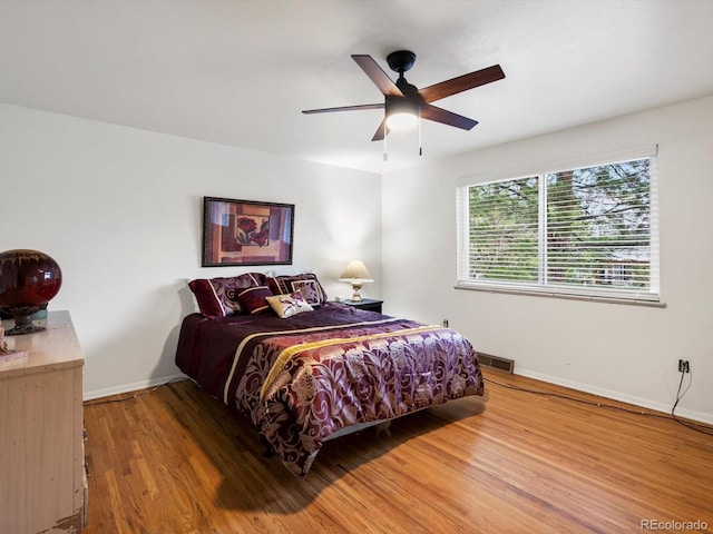 5845 W Portland Dr, Littleton, CO 80128 - bedroom featuring baseboards, wood finished floors, and ceiling fan