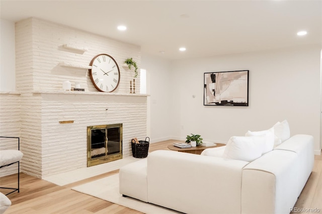 4395 Newland St, Wheat Ridge, CO 80033 - living room featuring wood finished floors, recessed lighting, a large fireplace, and baseboards