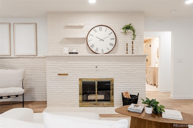 4395 Newland St, Wheat Ridge, CO 80033 - living room with light wood-type flooring, recessed lighting, baseboards, and a fireplace