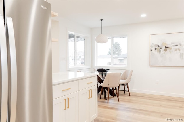 4395 Newland St, Wheat Ridge, CO 80033 - dining area with light wood-type flooring, recessed lighting, and baseboards