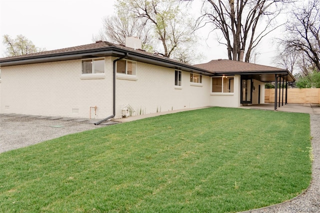 4395 Newland St, Wheat Ridge, CO 80033 - back of property with a patio, brick siding, and a chimney