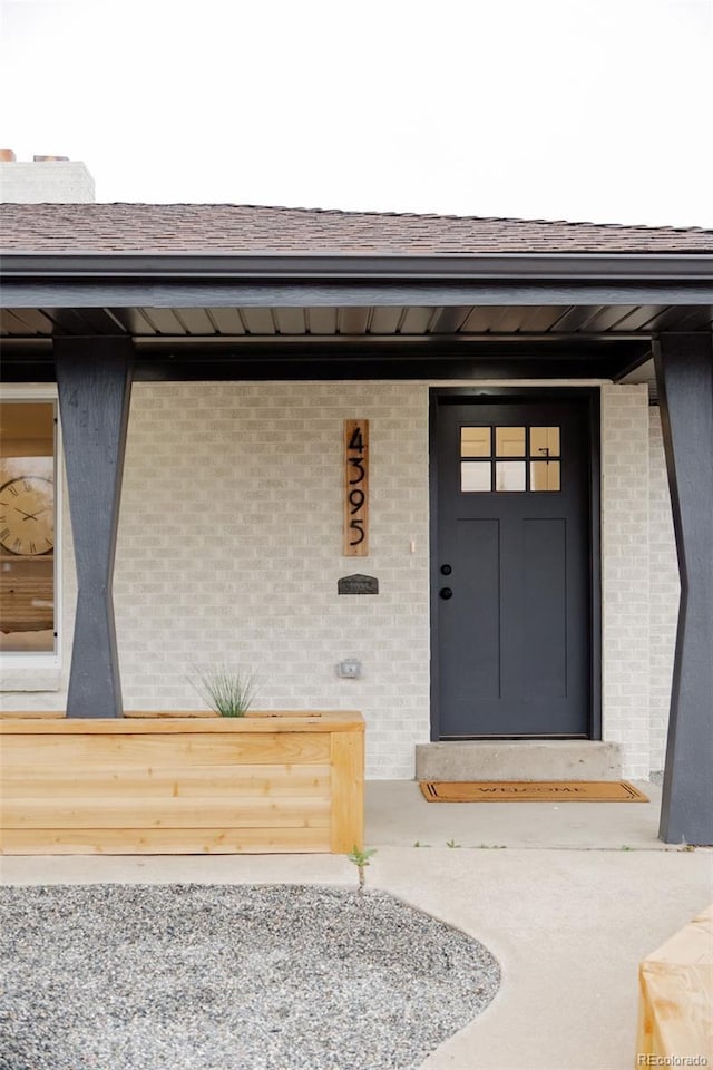 4395 Newland St, Wheat Ridge, CO 80033 - entrance to property featuring brick siding and a shingled roof