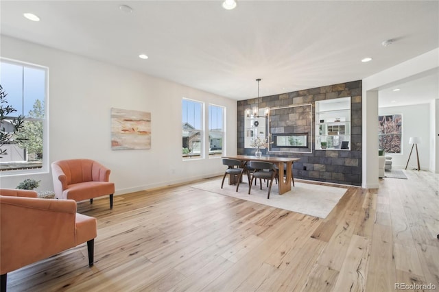 dining area featuring recessed lighting, an inviting chandelier, light wood-style floors, and baseboards
