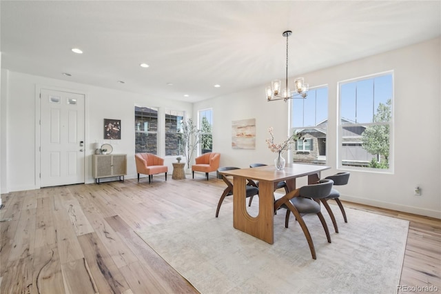 dining room featuring recessed lighting, light wood finished floors, baseboards, and an inviting chandelier