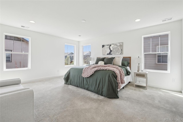 carpeted bedroom with recessed lighting, visible vents, and baseboards