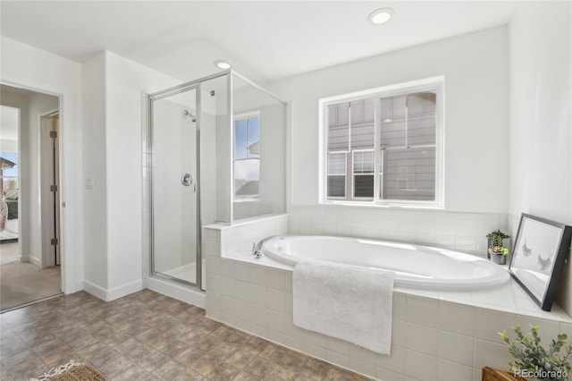 full bath with a bath and a stall shower