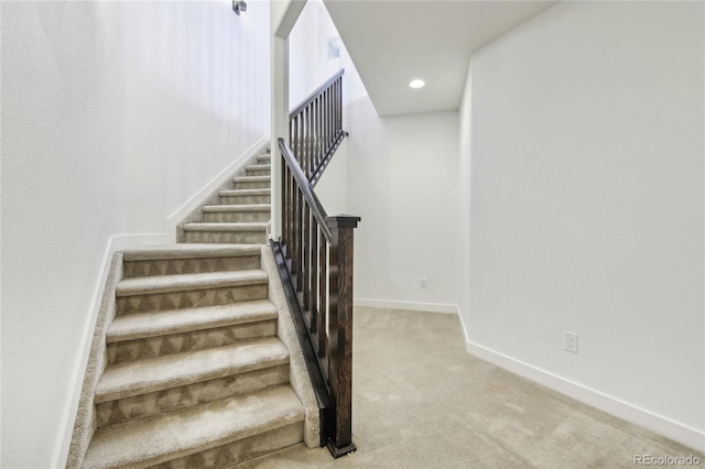 stairs with recessed lighting, baseboards, and carpet