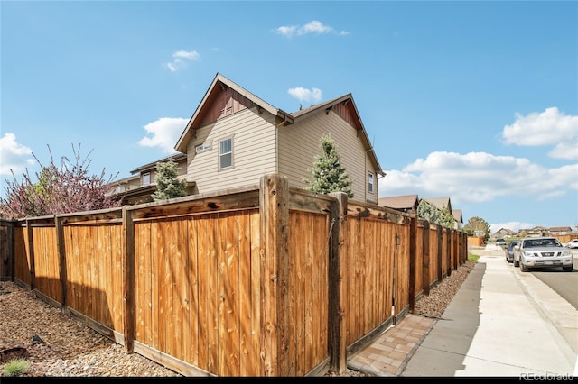 view of side of property featuring fence