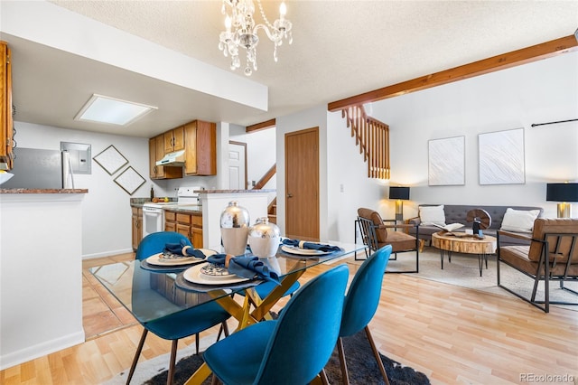 942 S Walden St Unit 204, Aurora, CO 80017 - dining area featuring a textured ceiling, baseboards, stairs, electric panel, and light wood-style floors