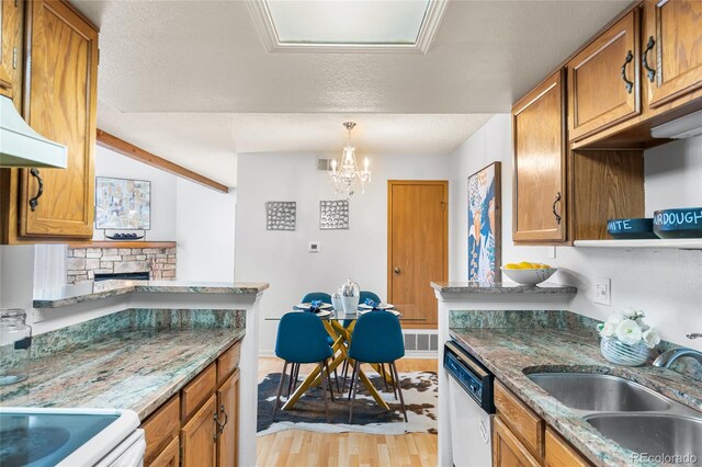 942 S Walden St Unit 204, Aurora, CO 80017 - kitchen with dishwasher, light wood-style floors, brown cabinetry, and a sink