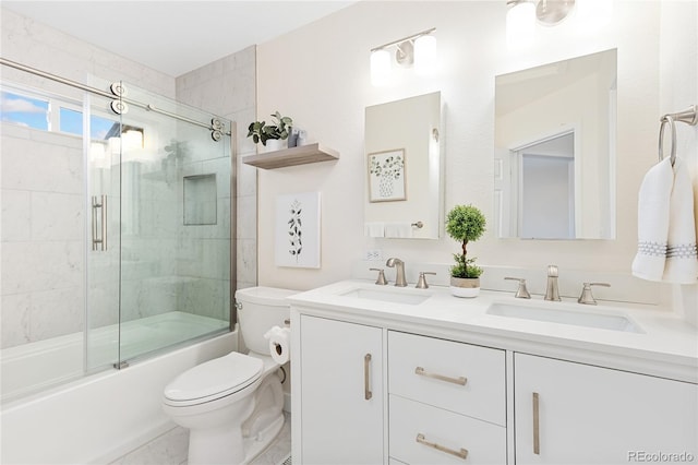 2017 N Fork Dr, Lafayette, CO 80026 - full bathroom featuring toilet, double vanity, and combined bath / shower with glass door