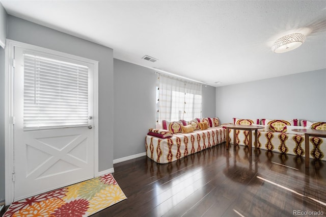 foyer featuring a textured ceiling and dark hardwood / wood-style floors