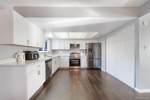 kitchen featuring appliances with stainless steel finishes, sink, and white cabinets