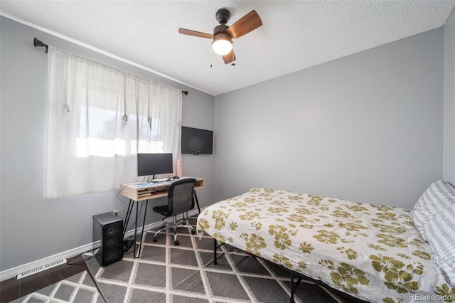 bedroom with a textured ceiling and ceiling fan