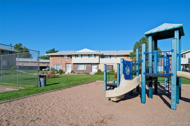 view of playground with a lawn