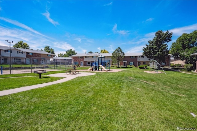 view of property's community featuring a playground and a yard