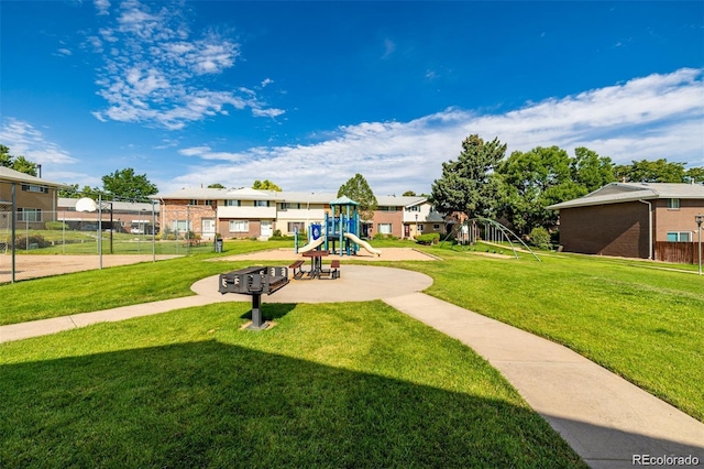 view of property's community with a playground and a yard