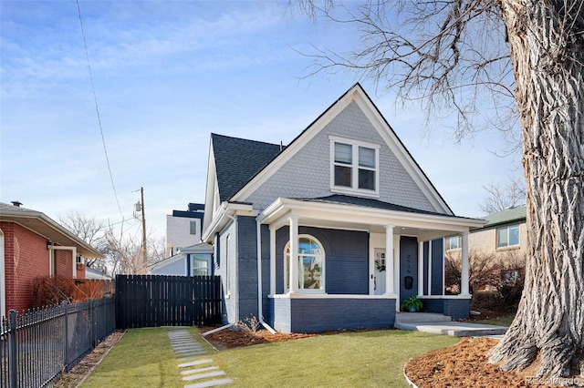 bungalow-style house with covered porch and a front yard