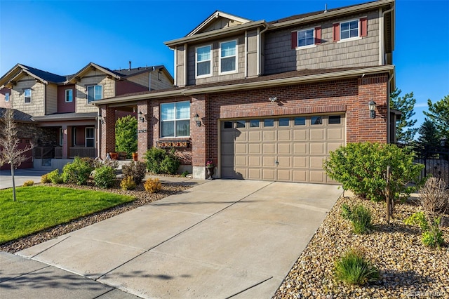 27029 E Irish Pl, Aurora, CO 80016 - view of front of house with a garage, brick siding, and driveway