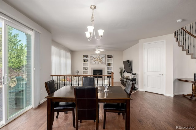 27029 E Irish Pl, Aurora, CO 80016 - dining area featuring a chandelier, wood finished floors, ceiling fan, a fireplace, and stairway
