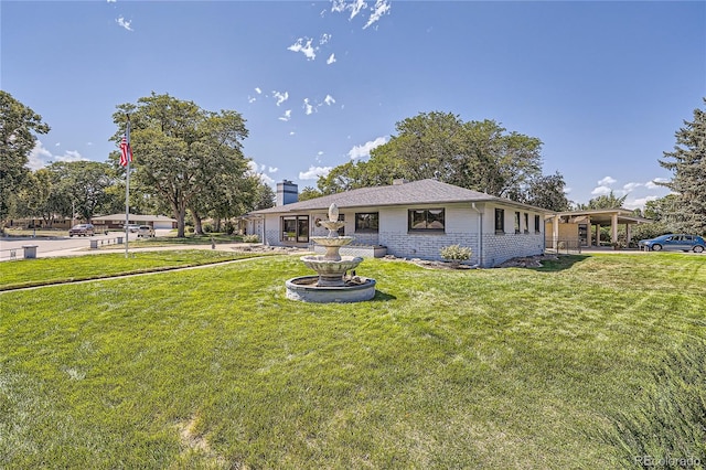 rear view of property with a yard